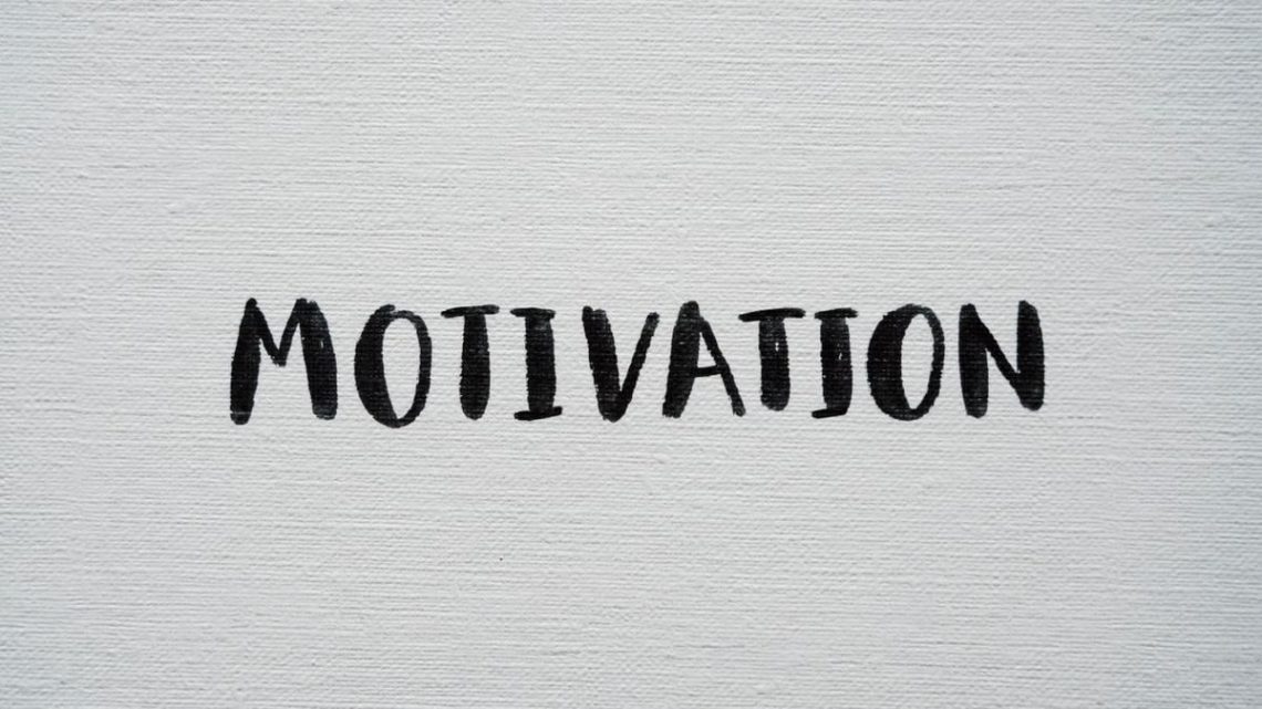 Inspirational word 'Motivation' in black on a white textured canvas background.